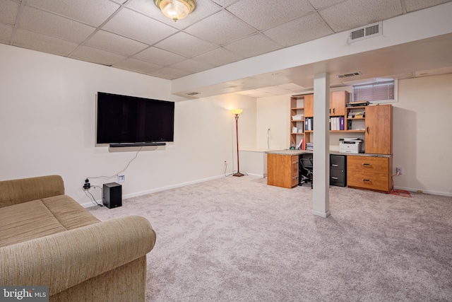 interior space with a drop ceiling and light carpet