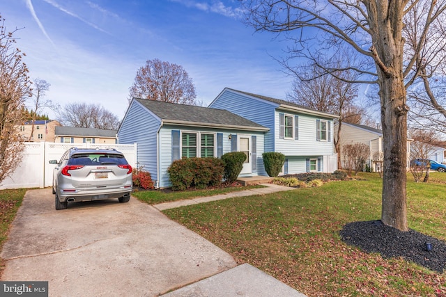 split level home featuring a front lawn