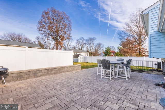 view of patio with a storage unit