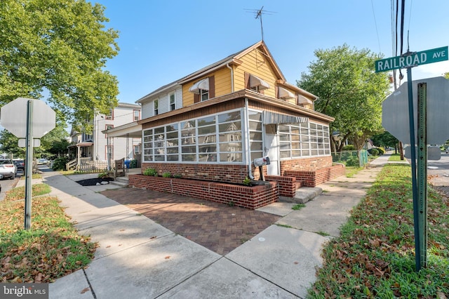 view of front of home featuring a sunroom