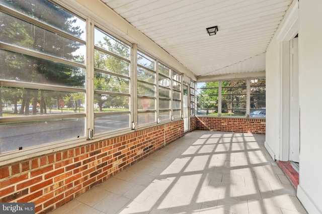 unfurnished sunroom with vaulted ceiling