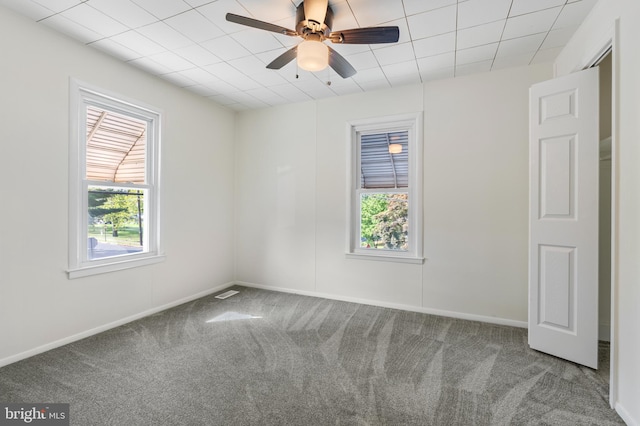 spare room with ceiling fan and carpet floors