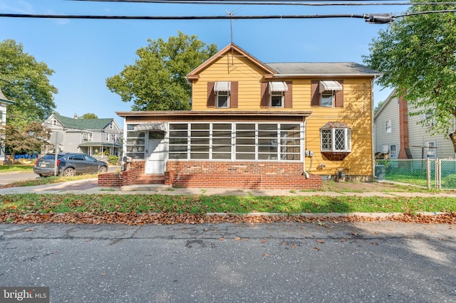 view of front of home featuring a sunroom