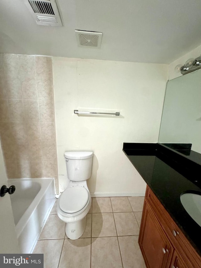 bathroom featuring tile patterned floors, vanity, and toilet