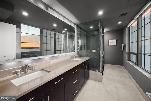 bathroom with tile patterned flooring, vanity, and a shower with shower door