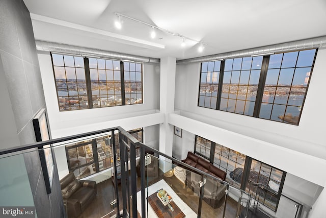 staircase featuring hardwood / wood-style flooring and track lighting