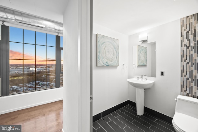 bathroom featuring toilet and hardwood / wood-style flooring