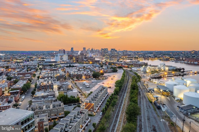 aerial view at dusk featuring a water view