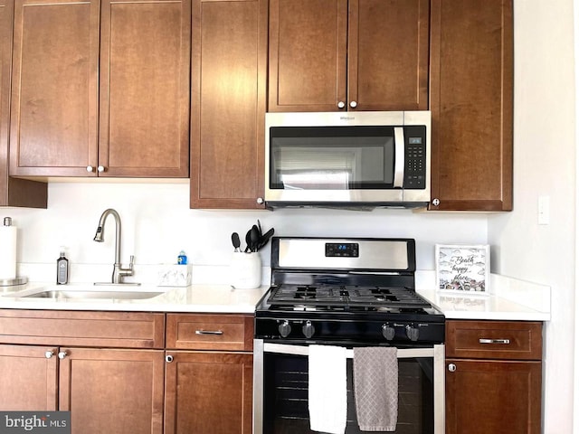 kitchen with sink and appliances with stainless steel finishes