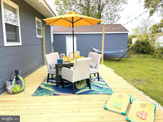 wooden terrace with a lawn