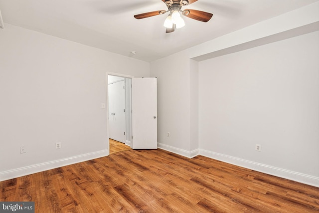 empty room with ceiling fan and light hardwood / wood-style floors