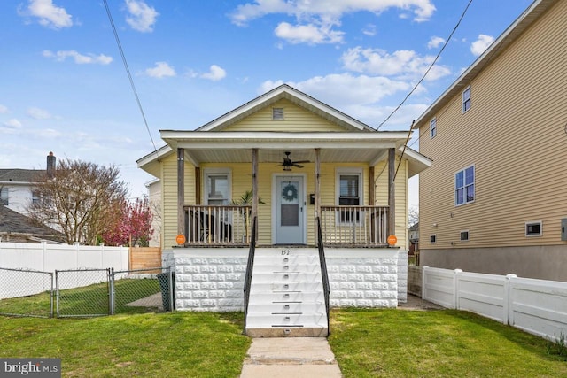 bungalow-style home with covered porch and a front lawn