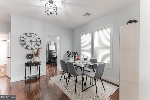 dining area with dark wood-type flooring