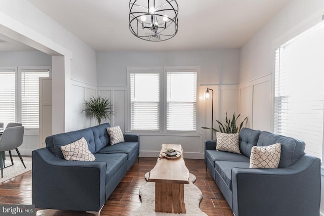 living room featuring plenty of natural light and dark hardwood / wood-style floors