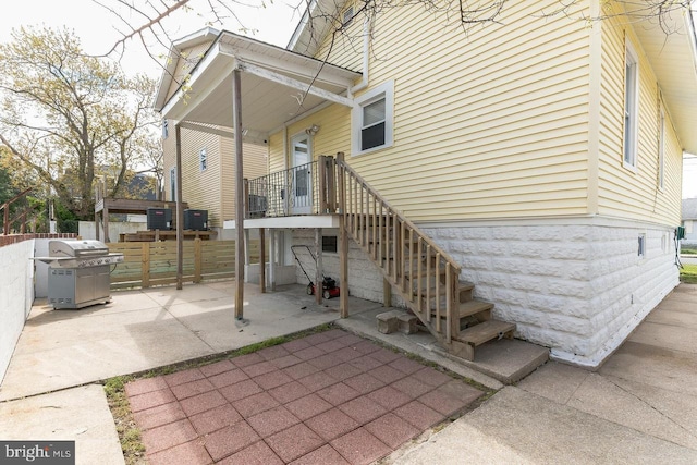 exterior space with central AC and a grill