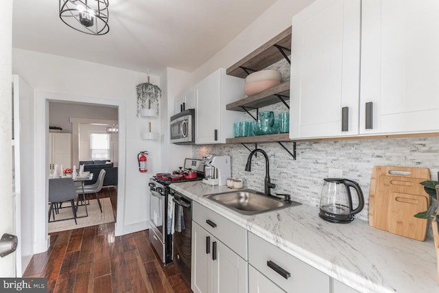 kitchen with dark wood-type flooring, white cabinetry, sink, and stainless steel appliances