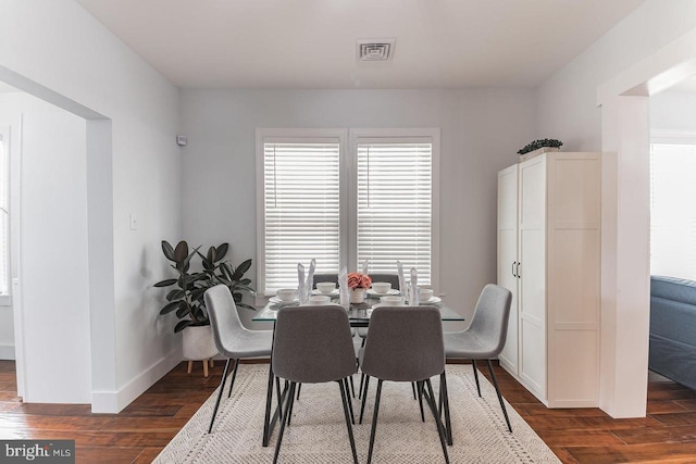 dining area with dark hardwood / wood-style flooring