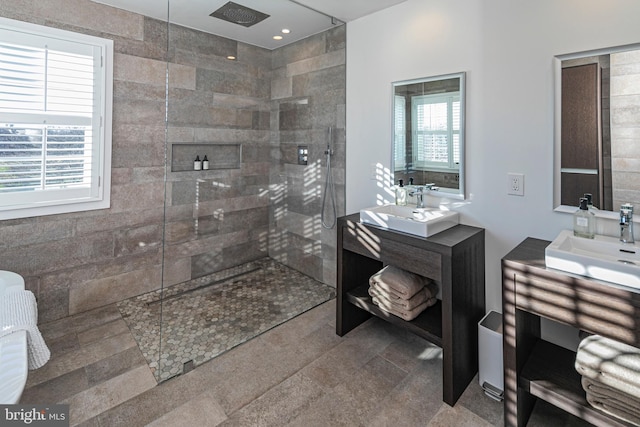 bathroom featuring a tile shower and vanity