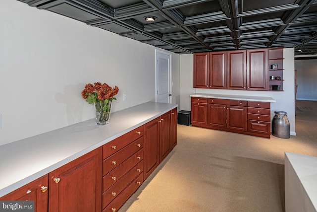 kitchen featuring light colored carpet and coffered ceiling