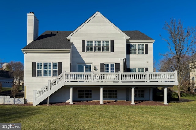 back of house featuring a wooden deck and a yard