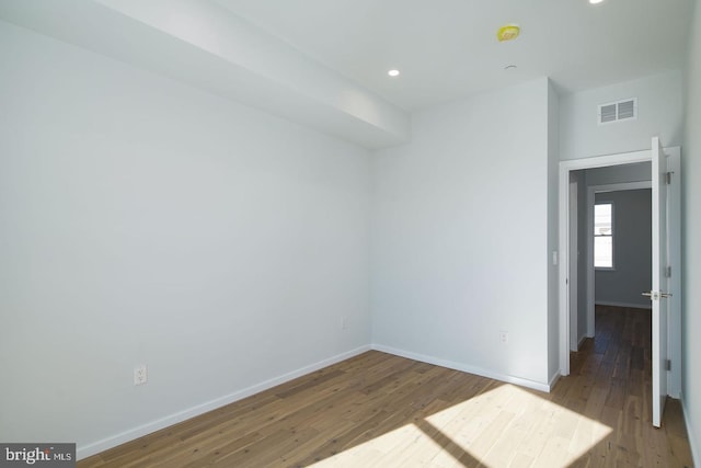 empty room with hardwood / wood-style flooring