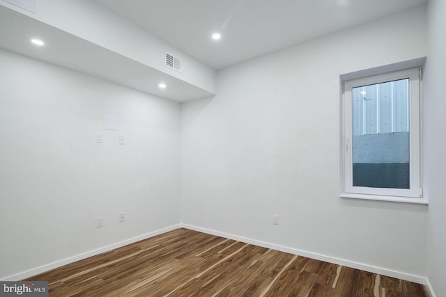 empty room with hardwood / wood-style floors