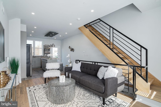 living room featuring light hardwood / wood-style flooring and sink