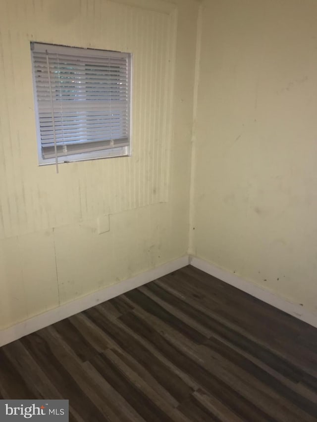 spare room featuring dark wood-type flooring