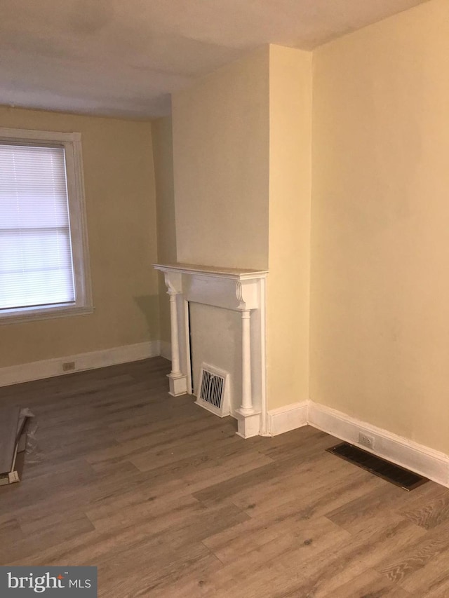 unfurnished living room with dark hardwood / wood-style floors