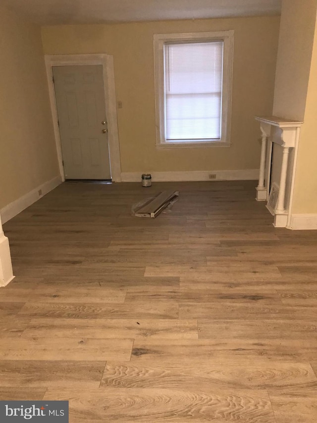 unfurnished living room featuring light wood-type flooring