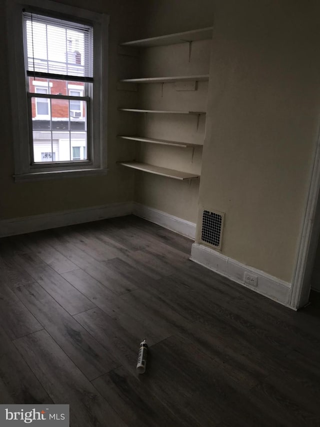 unfurnished room featuring dark hardwood / wood-style flooring