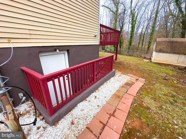 view of side of home with a shed and a deck