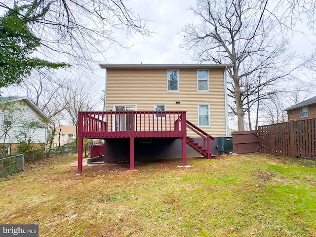 back of property with a yard, central AC, and a wooden deck