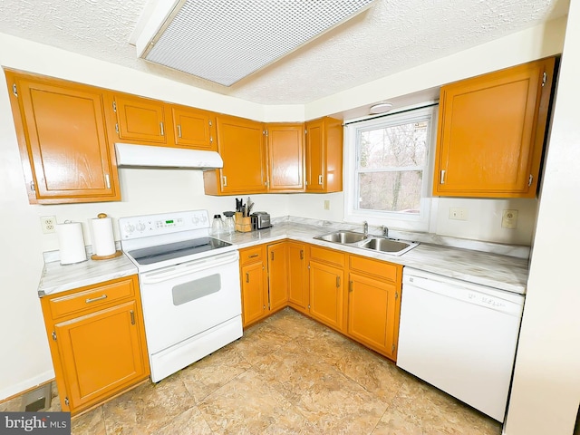 kitchen with sink, white appliances, and a textured ceiling