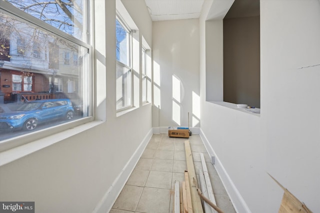 hallway with light tile patterned floors