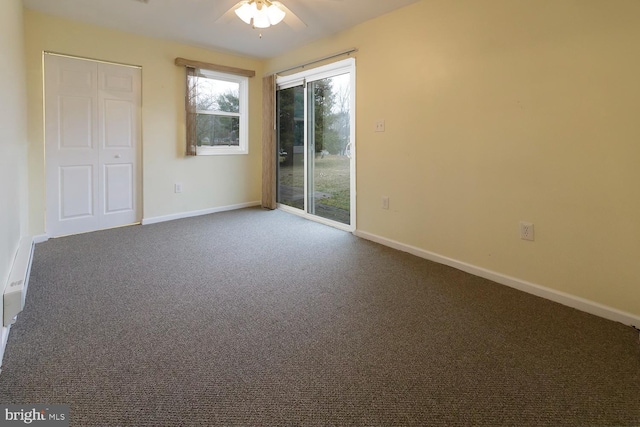 unfurnished room with ceiling fan and carpet flooring