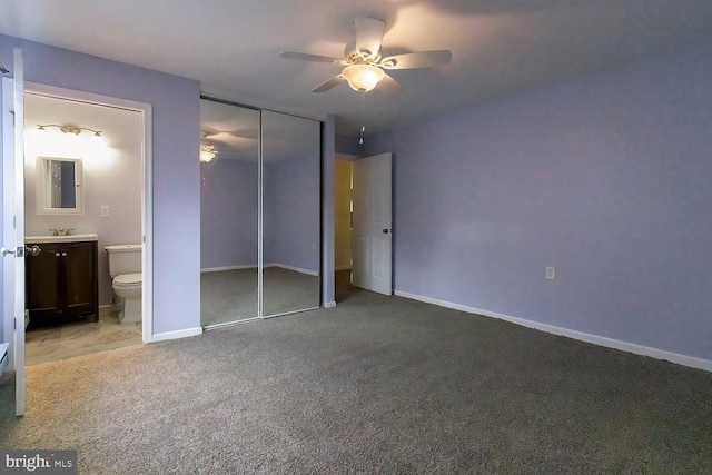 unfurnished bedroom with sink, ensuite bath, light carpet, a closet, and ceiling fan