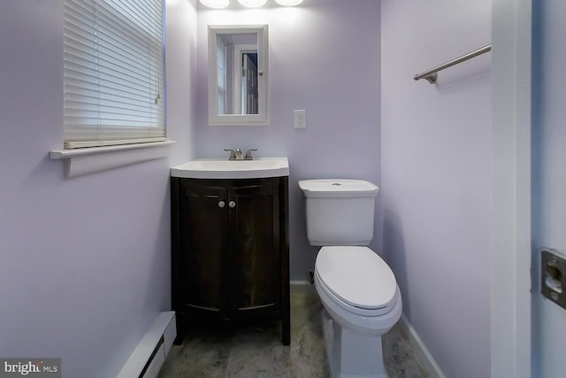 bathroom with vanity, toilet, and baseboard heating