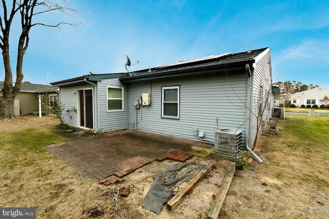 back of property featuring a lawn, central AC, and a patio area