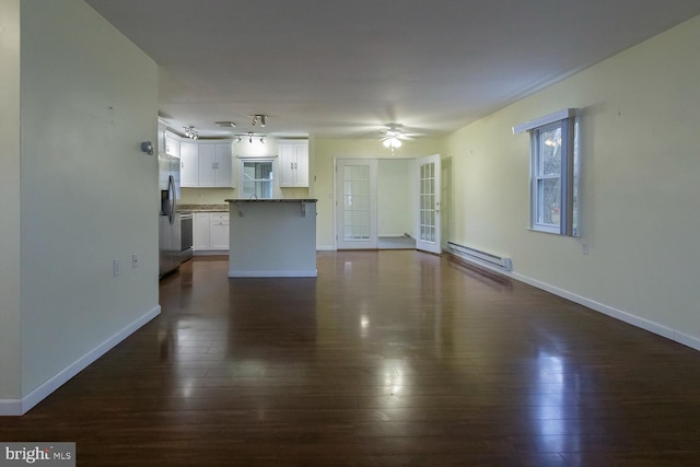 unfurnished living room with a baseboard radiator, dark hardwood / wood-style floors, and ceiling fan