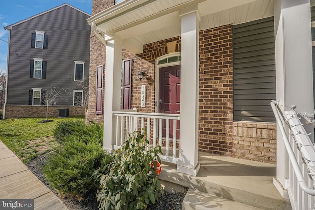 property entrance featuring a porch and cooling unit