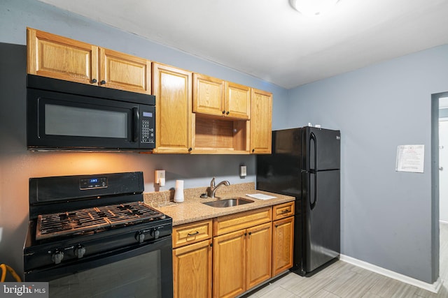 kitchen with black appliances and sink