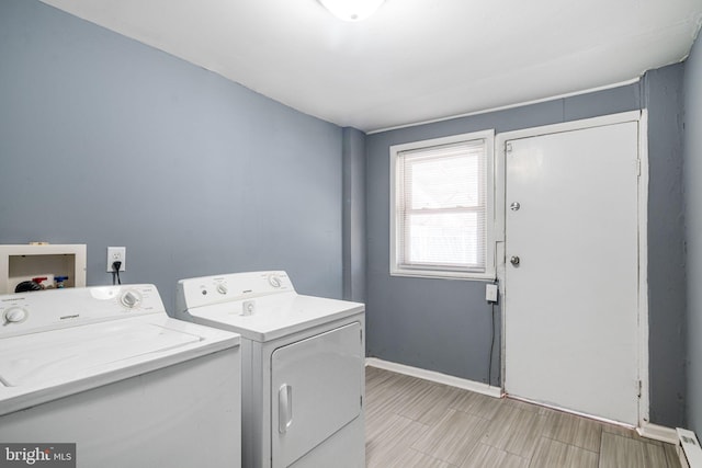 laundry area with independent washer and dryer and a baseboard heating unit