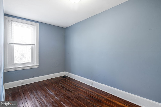 empty room featuring dark hardwood / wood-style flooring