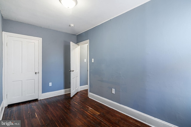 unfurnished bedroom featuring dark wood-type flooring