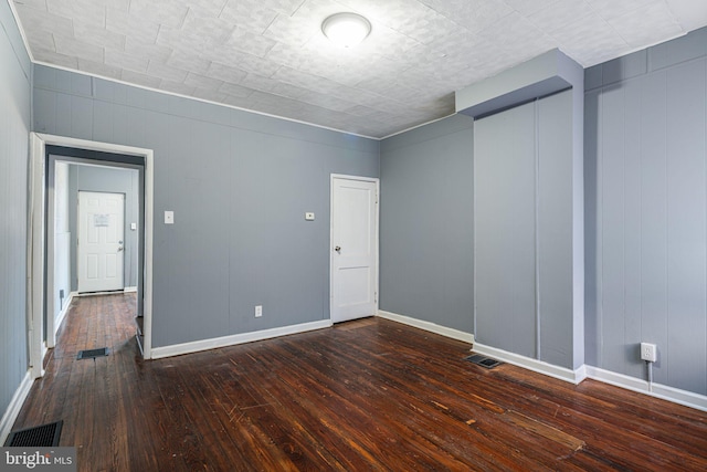 unfurnished room featuring dark hardwood / wood-style floors