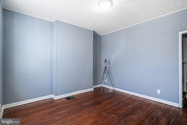 unfurnished room with dark hardwood / wood-style flooring