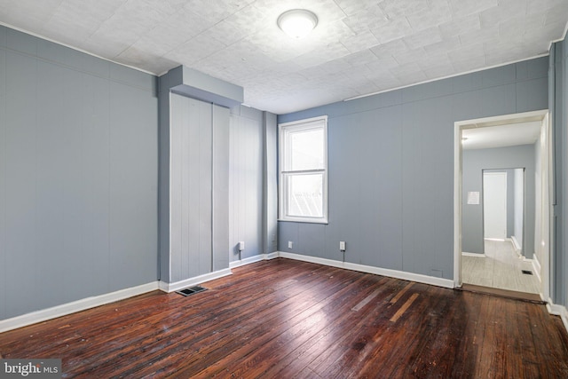 spare room featuring dark hardwood / wood-style flooring