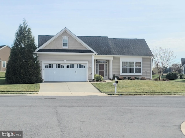 view of front of home with a garage and a front lawn