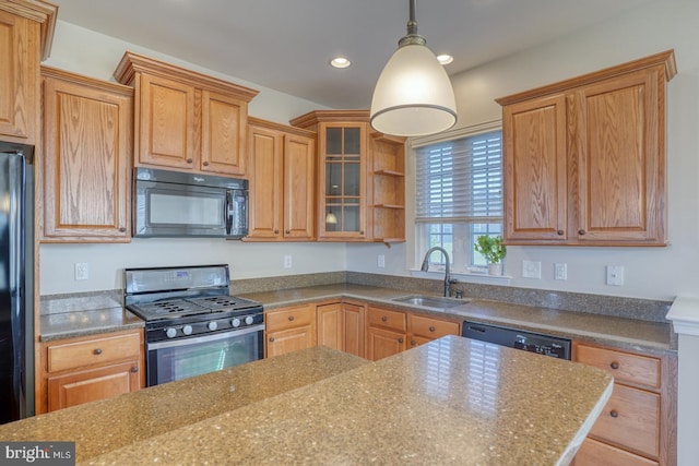 kitchen featuring sink, decorative light fixtures, and black appliances